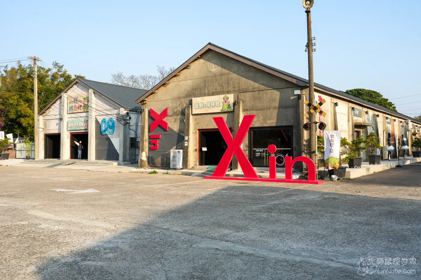 水泥倉庫改建的園區建築與門前的紅色英文字裝置